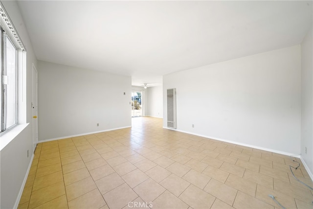 tiled spare room featuring plenty of natural light