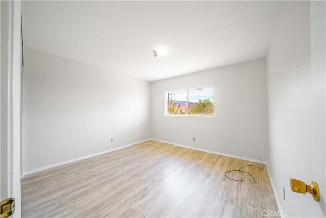 spare room with light hardwood / wood-style floors