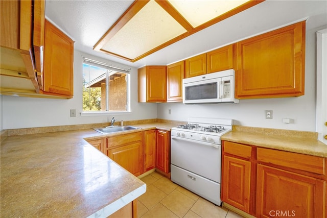 kitchen featuring white appliances, a textured ceiling, light tile patterned floors, and sink