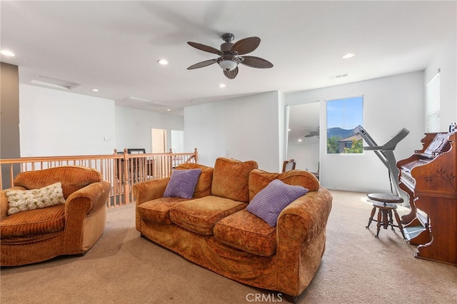 carpeted living room with ceiling fan