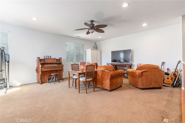 carpeted living room featuring ceiling fan and a healthy amount of sunlight