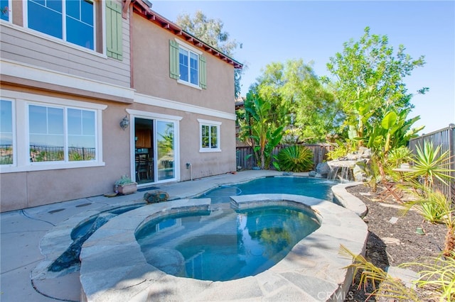 view of swimming pool with an in ground hot tub