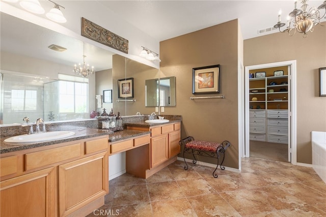 bathroom featuring built in shelves, vanity, a notable chandelier, and separate shower and tub