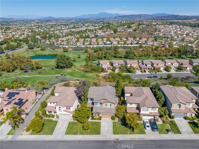 drone / aerial view featuring a water and mountain view