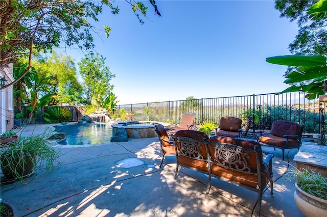 view of patio / terrace featuring a swimming pool with hot tub