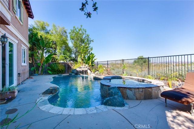 view of swimming pool with pool water feature, an in ground hot tub, and a patio