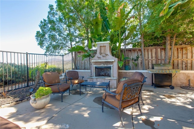 view of patio / terrace featuring an outdoor fireplace