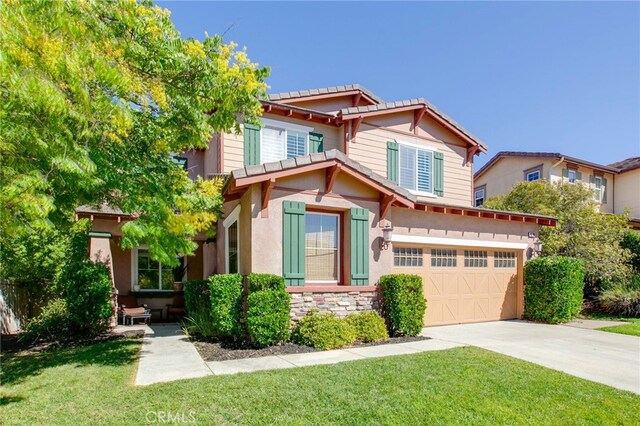 craftsman inspired home featuring a front yard and a garage