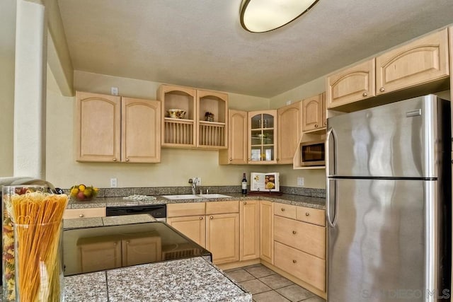 kitchen with light brown cabinetry, appliances with stainless steel finishes, and sink