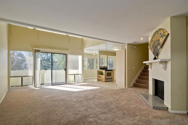 unfurnished living room featuring light colored carpet