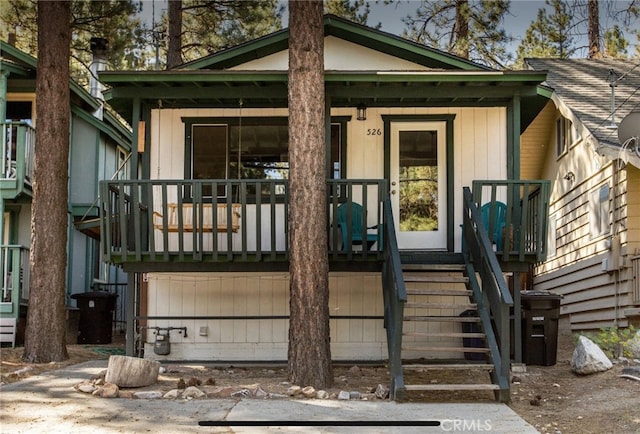 view of exterior entry featuring covered porch