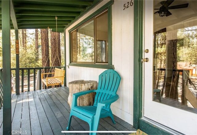 wooden deck featuring ceiling fan