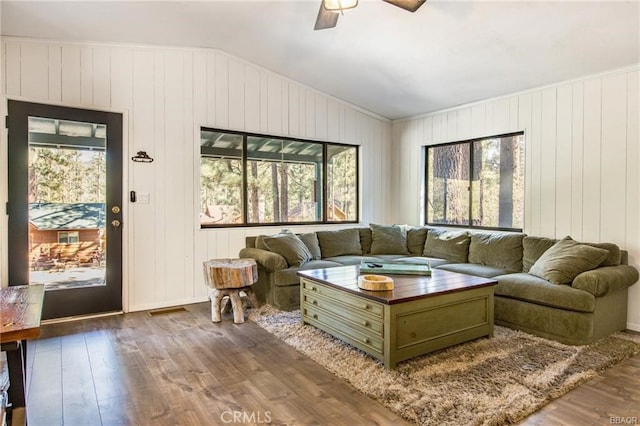 living room featuring hardwood / wood-style flooring, plenty of natural light, and vaulted ceiling