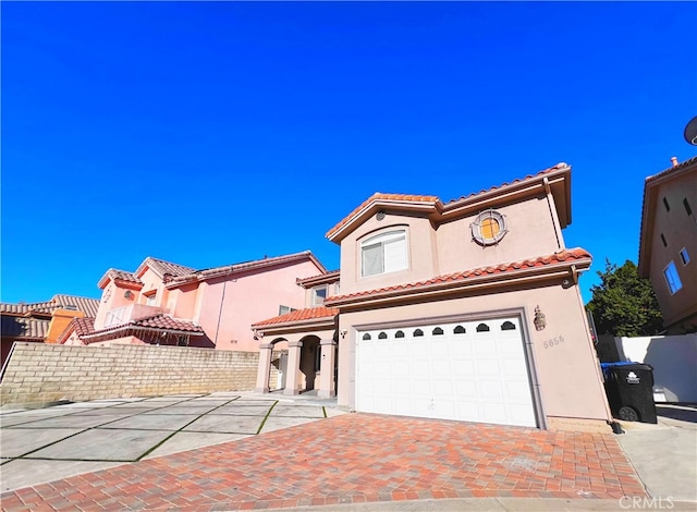 mediterranean / spanish house with a garage