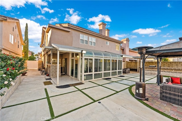 back of property with a gazebo and a patio