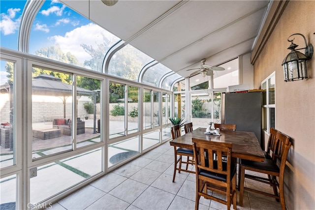 sunroom / solarium featuring ceiling fan