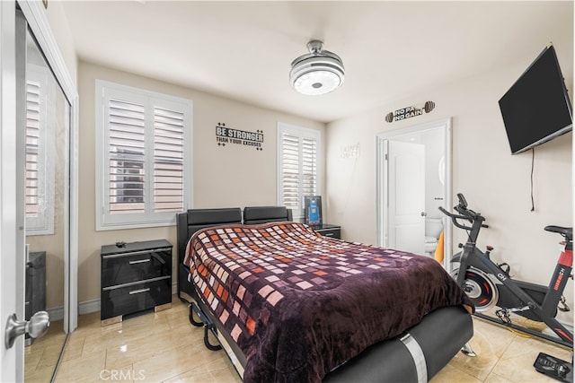 tiled bedroom with a closet