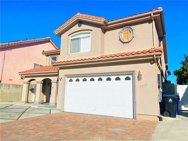 mediterranean / spanish-style house featuring a garage