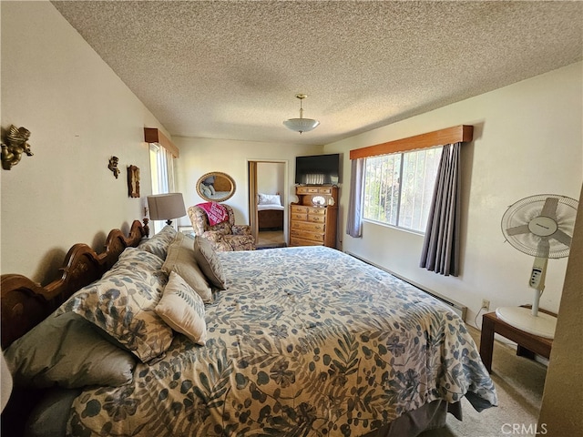 bedroom featuring carpet floors and a textured ceiling