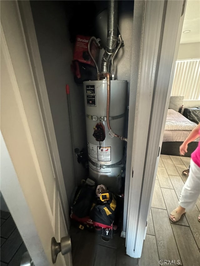 utility room featuring water heater