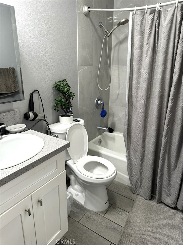 full bathroom featuring shower / tub combo, vanity, and toilet