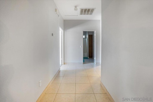 hall featuring light tile patterned flooring