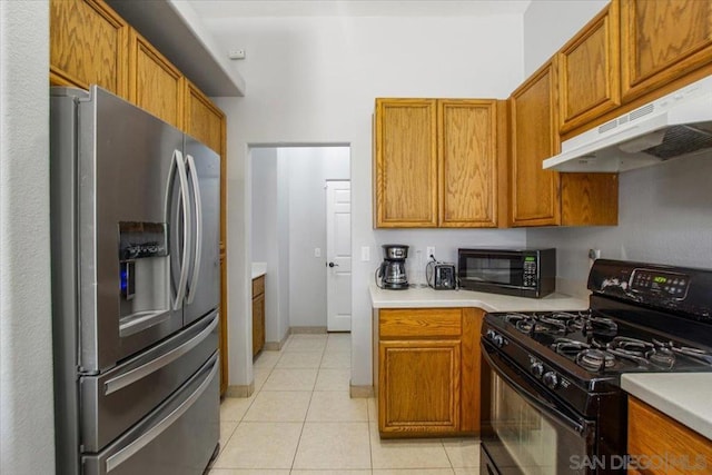 kitchen with black appliances and light tile patterned floors