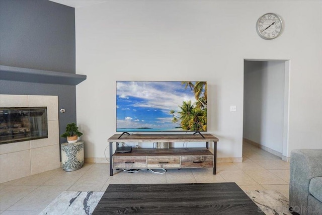 living room with light tile patterned flooring and a tile fireplace