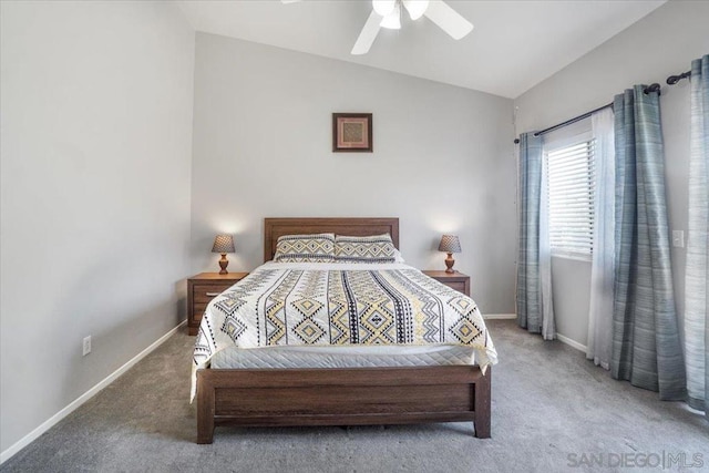 bedroom with ceiling fan, lofted ceiling, and carpet flooring