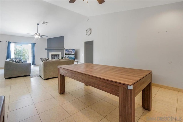 dining space featuring lofted ceiling, ceiling fan, and light tile patterned floors