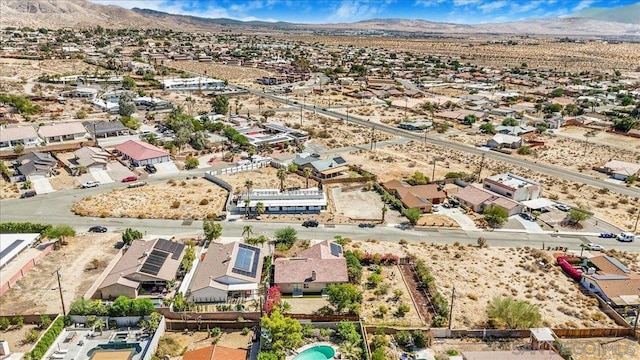 birds eye view of property with a mountain view