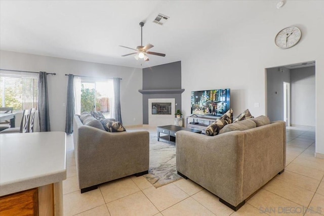 living room featuring light tile patterned flooring, high vaulted ceiling, and ceiling fan