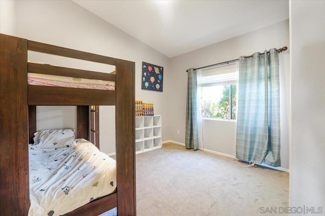 bedroom featuring vaulted ceiling and carpet