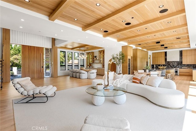 living room with beam ceiling, light hardwood / wood-style flooring, and wooden ceiling