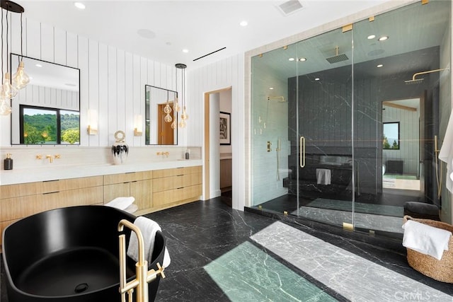 bathroom featuring vanity and a shower with shower door