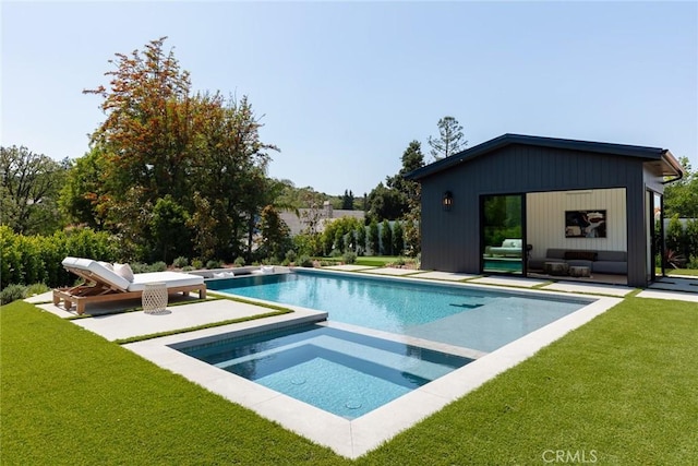 view of pool with a patio area, an in ground hot tub, and a yard