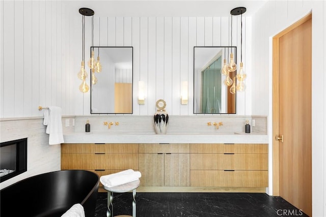 bathroom with vanity and a tub