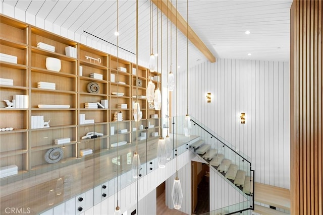 interior space with vaulted ceiling with beams, wood-type flooring, wooden walls, and wooden ceiling