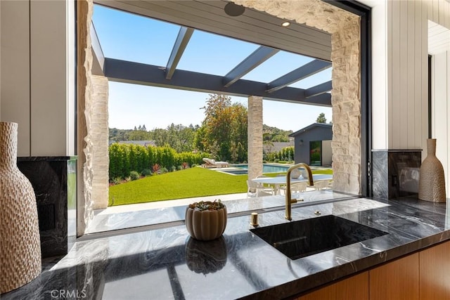 view of patio featuring a pool and sink