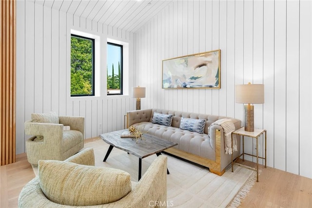 living area with wooden walls and light wood-type flooring