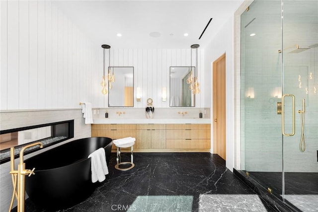 bathroom featuring wooden walls, vanity, and independent shower and bath