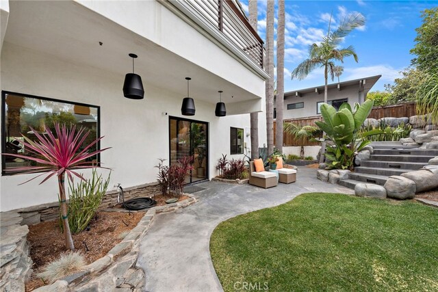 property entrance featuring a patio and a lawn