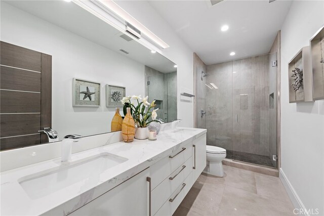 bathroom featuring vanity, a shower with shower door, toilet, and tile patterned flooring