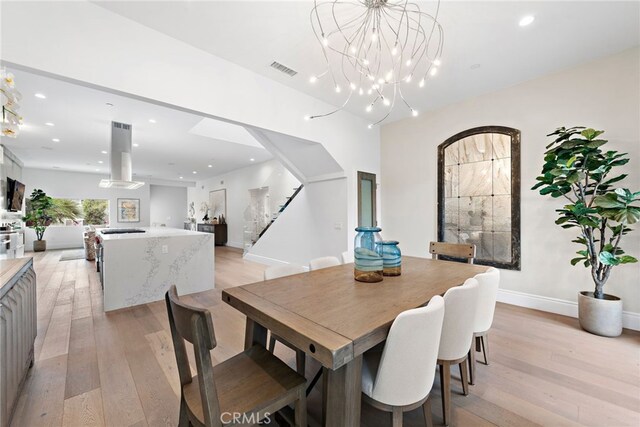 dining room featuring a chandelier and light wood-type flooring