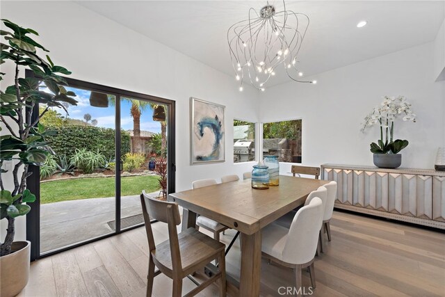 dining room featuring an inviting chandelier and light wood-type flooring