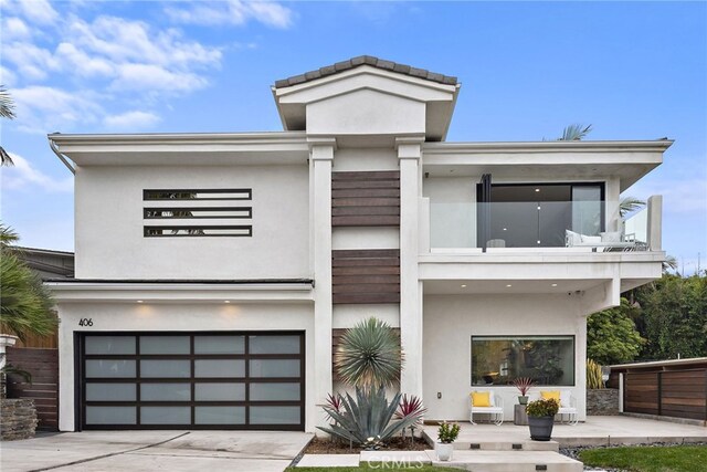 contemporary house featuring a balcony and a garage