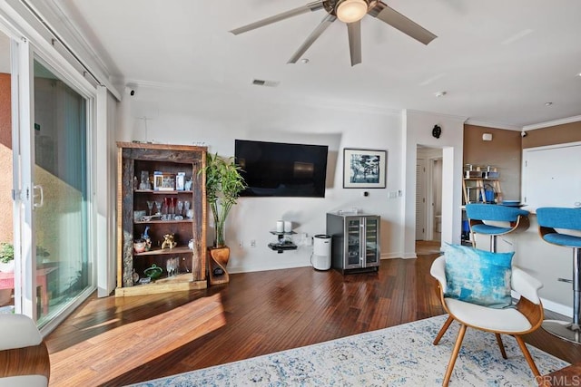 living room featuring ornamental molding, ceiling fan, and dark hardwood / wood-style flooring