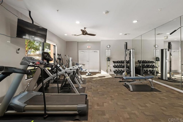 gym featuring ceiling fan and dark carpet