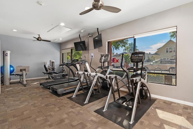 exercise room featuring ceiling fan and dark colored carpet