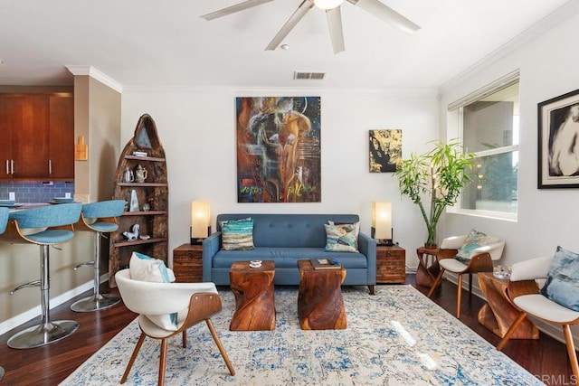 sitting room with ceiling fan, dark hardwood / wood-style floors, and crown molding